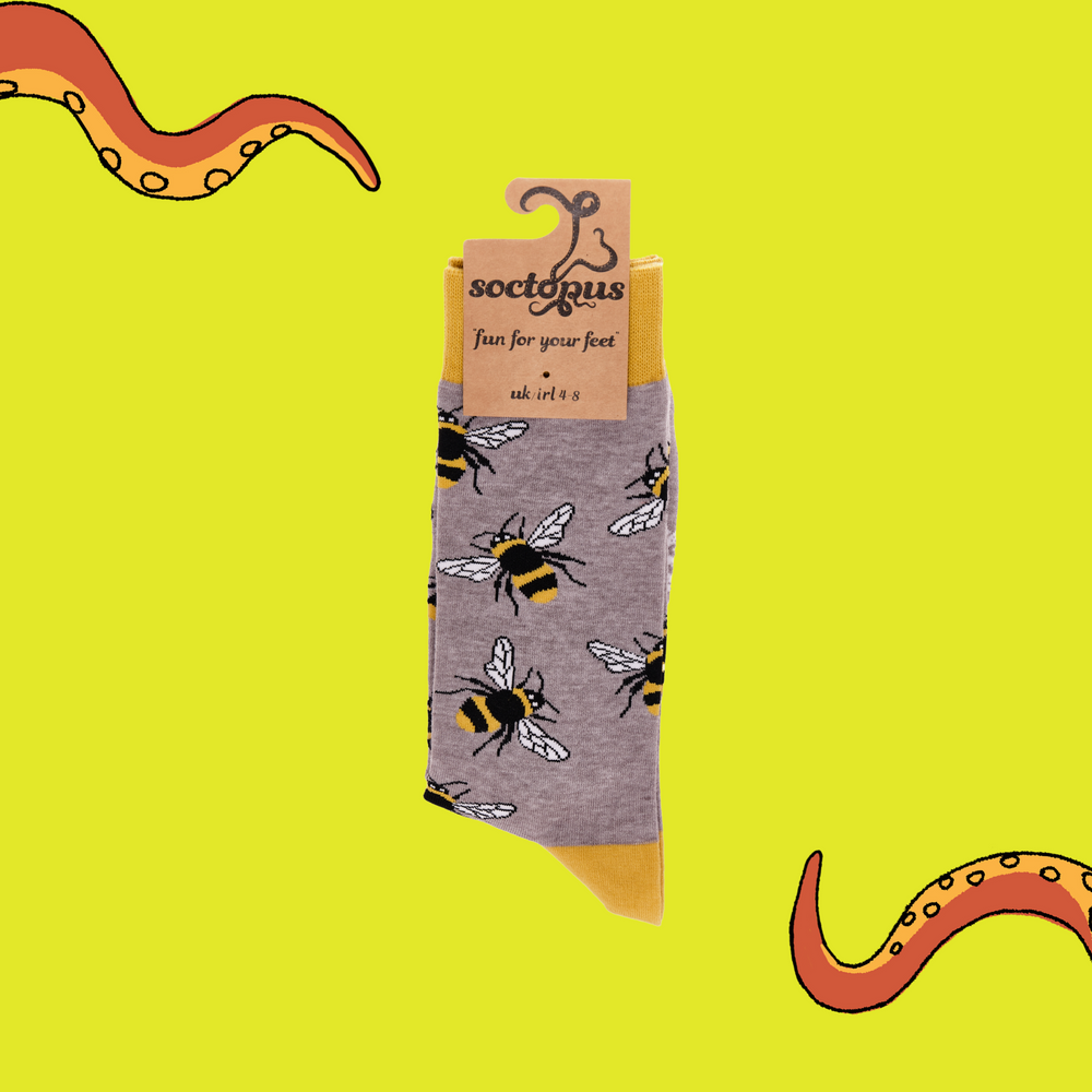 
                  
                    A pair of socks depicting Bees. Grey legs, yellow cuff, heel and toe. In Soctopus Packaging.
                  
                