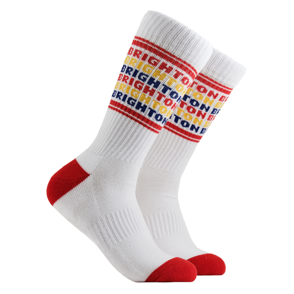Brighton Athletic Socks. Sports style socks with Brighton text in rainbow colours. White legs, red cuff, heel and toe.