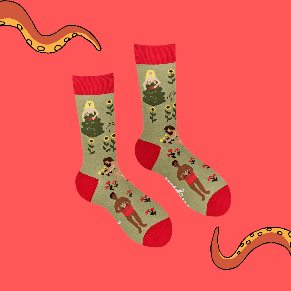 
                  
                    A pair of socks depicting naked gardeners. Green legs, red cuff, heel and toe.
                  
                