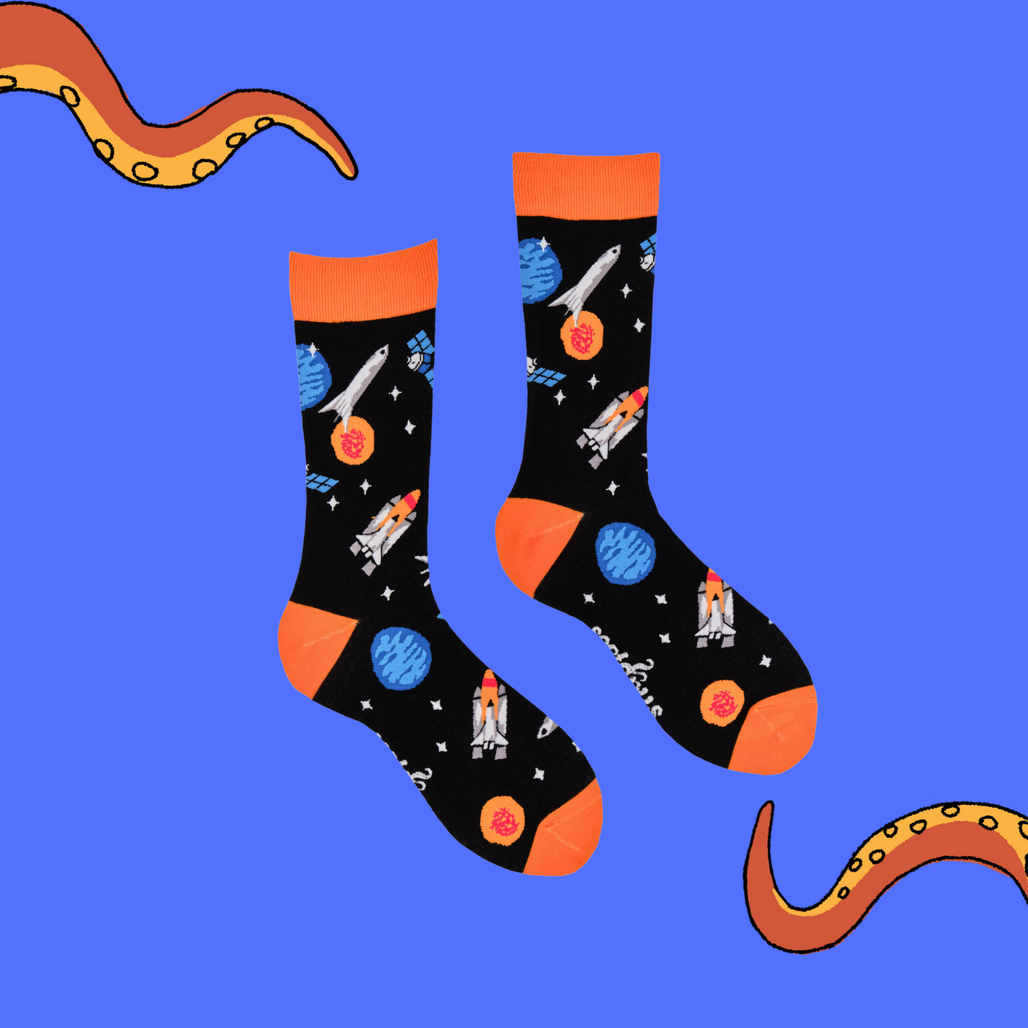 
                  
                    A pair of socks depicting space craft in space. Black legs, orange cuff, heel and toe.
                  
                