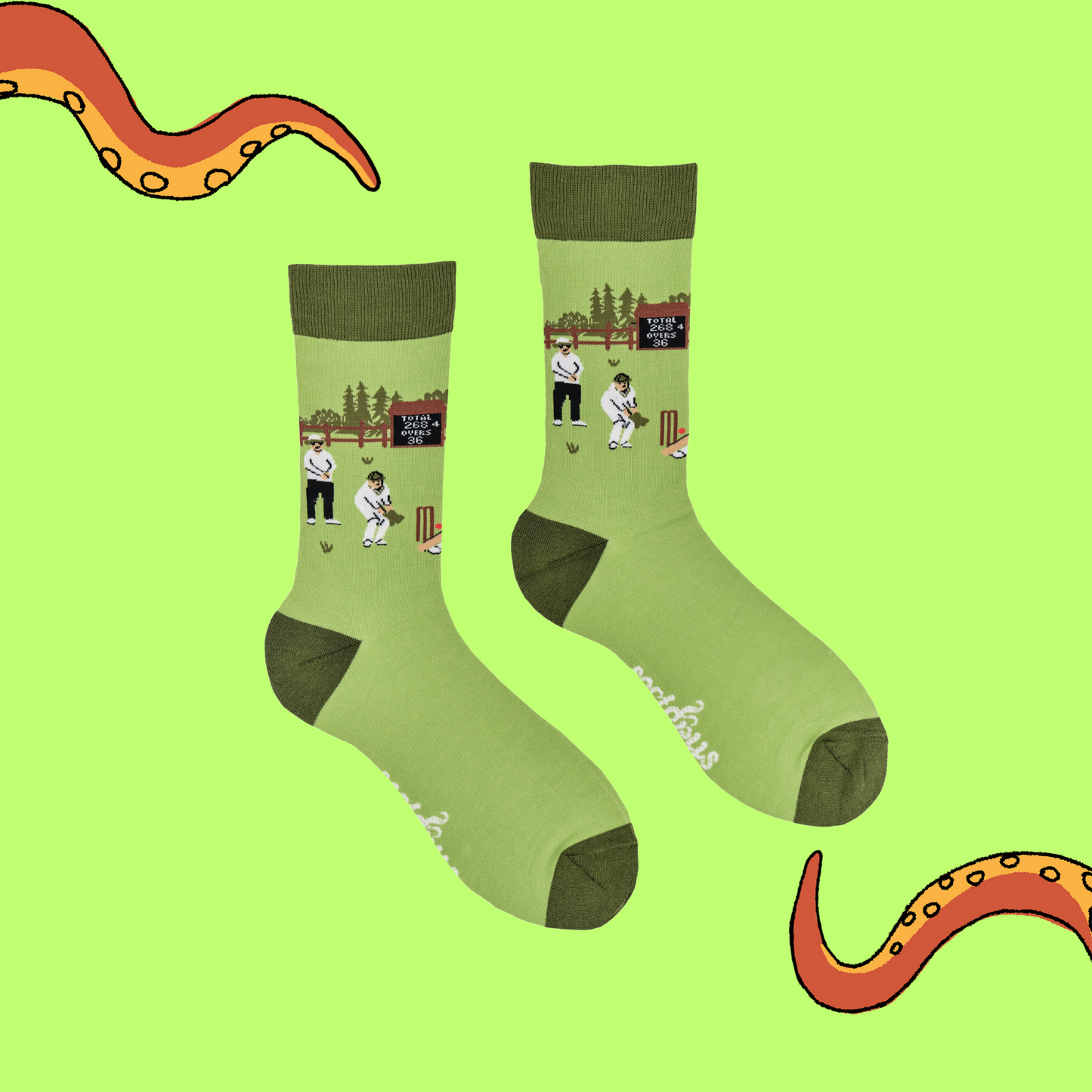 
                  
                    A pair of socks depicting a cricket match. Green legs, dark cuff, heel and toe.
                  
                