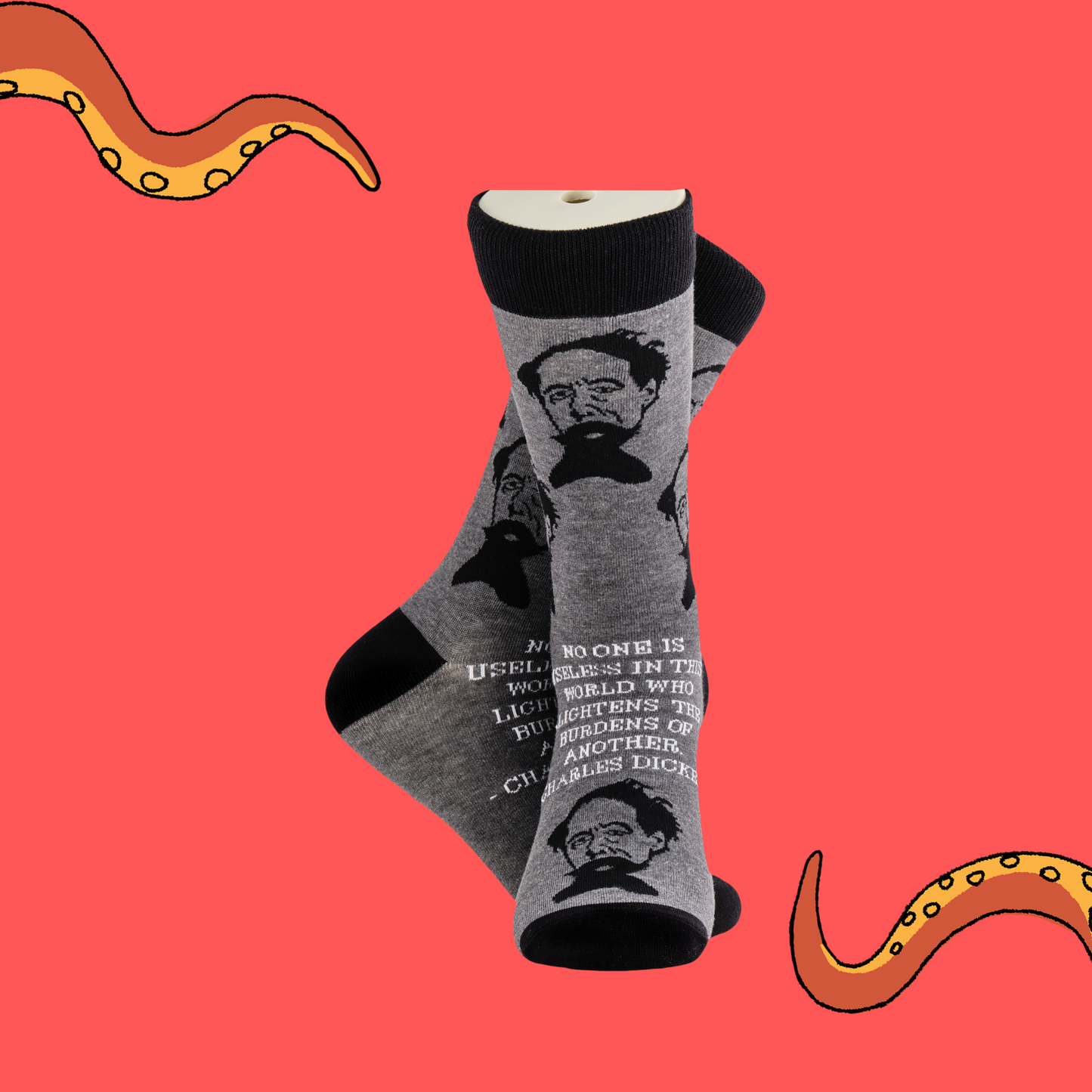 
                  
                    A pair of socks depicting Charles Dickens and a quote. Grey legs, black cuff, heel and toe.
                  
                