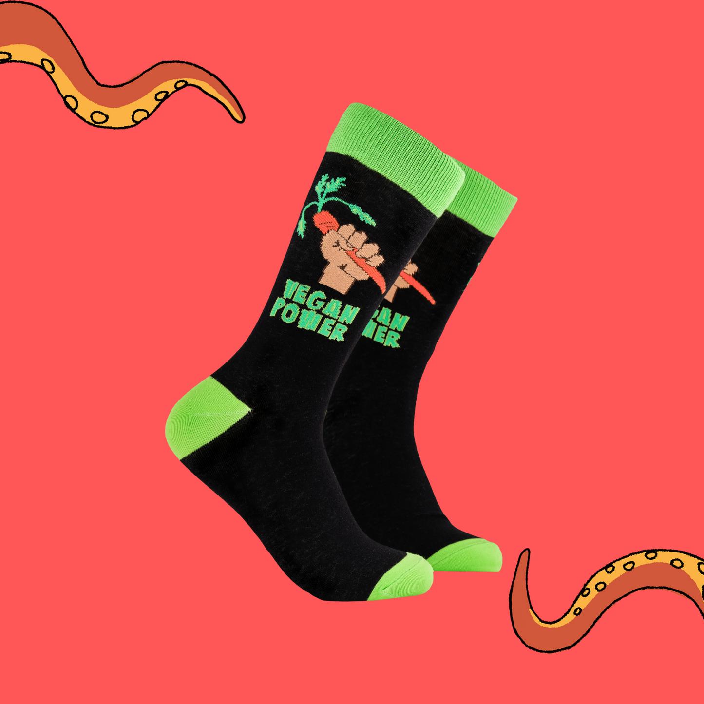A pair of socks depicting a fist holding a carrot and the phrase 'Vegan Power'. Black legs, bright green cuff, heel and toe.