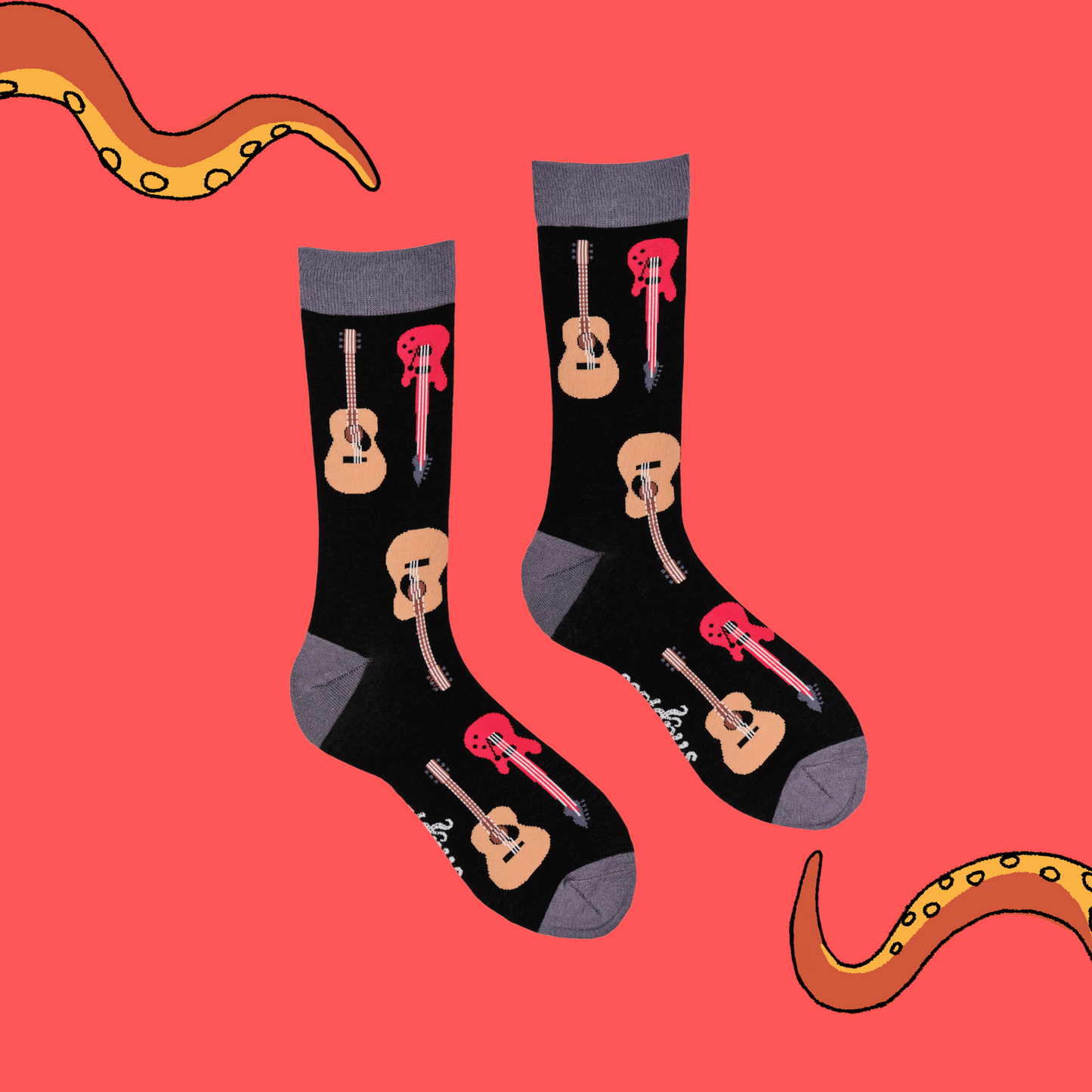 
                  
                    A pair of socks depicting electric and acoustic guitars. Black legs, grey cuff, heel and toe.
                  
                