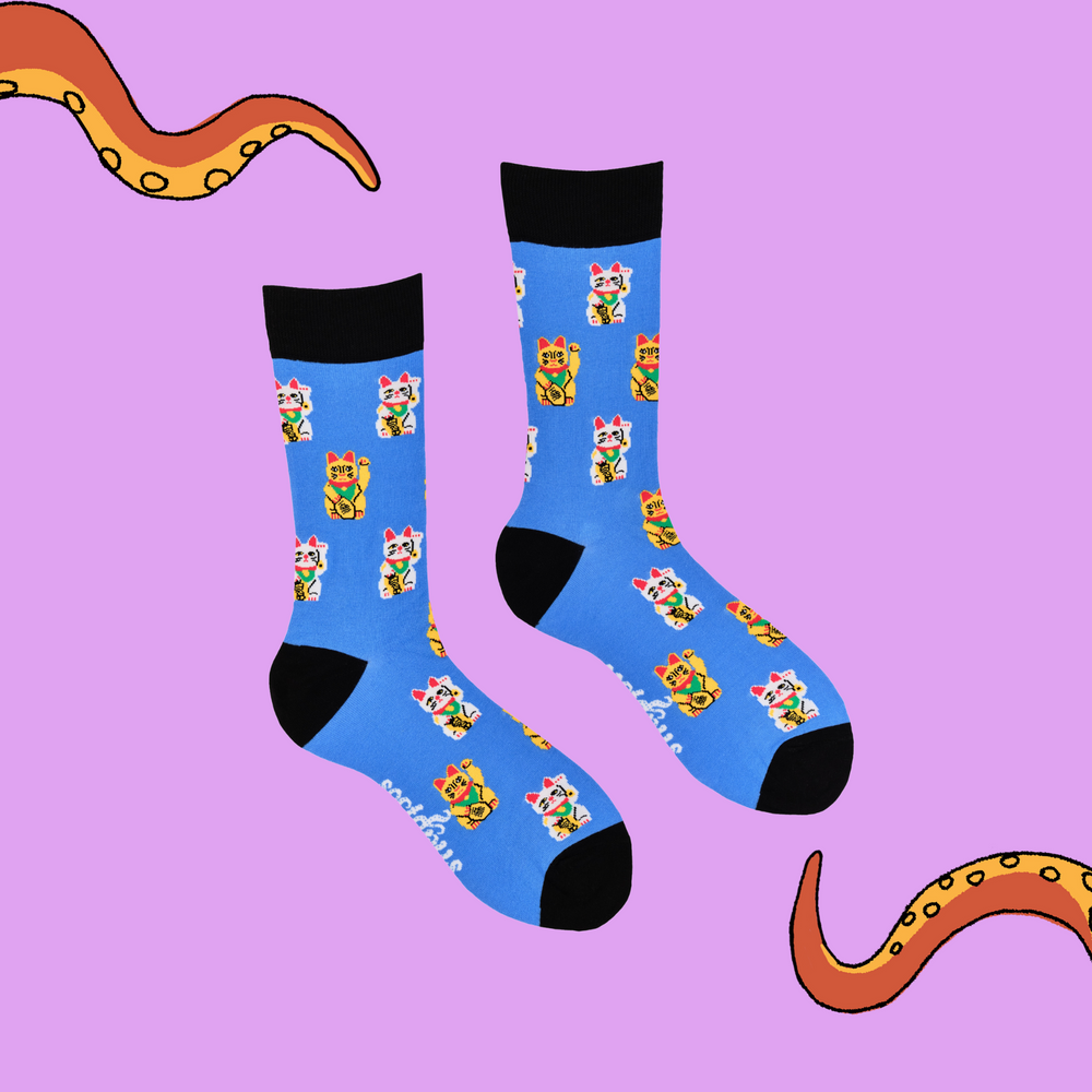 
                  
                    A pair of socks depicting lucky cats. Blue legs, black cuff, heel and toe.
                  
                