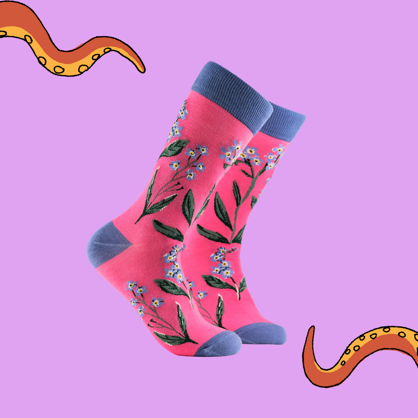 A pair of socks depicting forget me knot flowers. Pink legs, blue cuff, heel and toe.