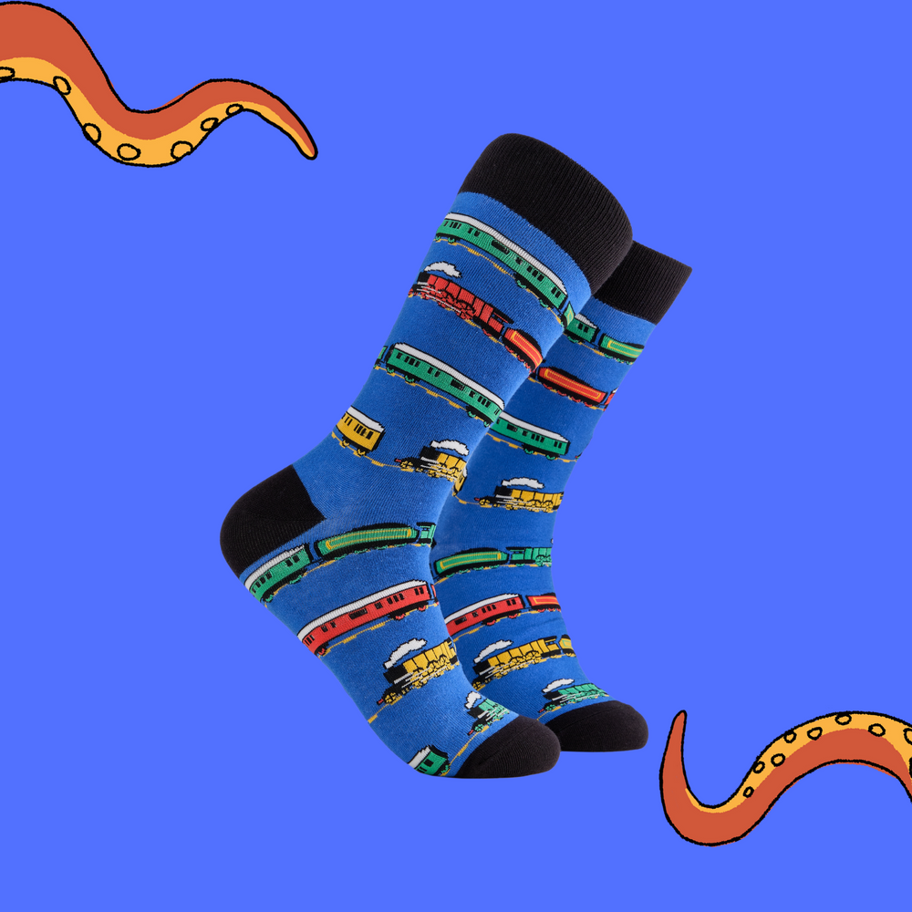 A pair of socks depicting a variety of trains. Blue legs, black cuff, heel and toe.