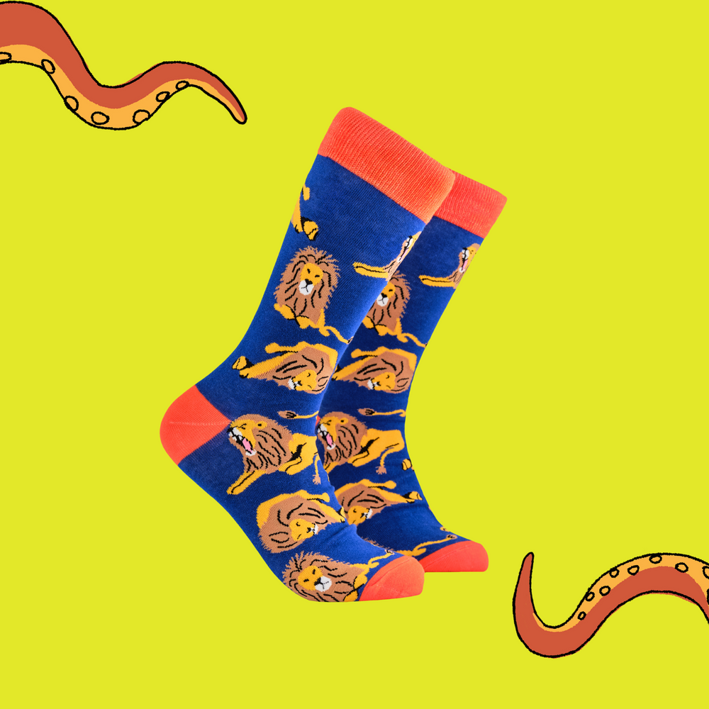 A pair of socks depicting lions. Blue legs, red cuff, heel and toe.