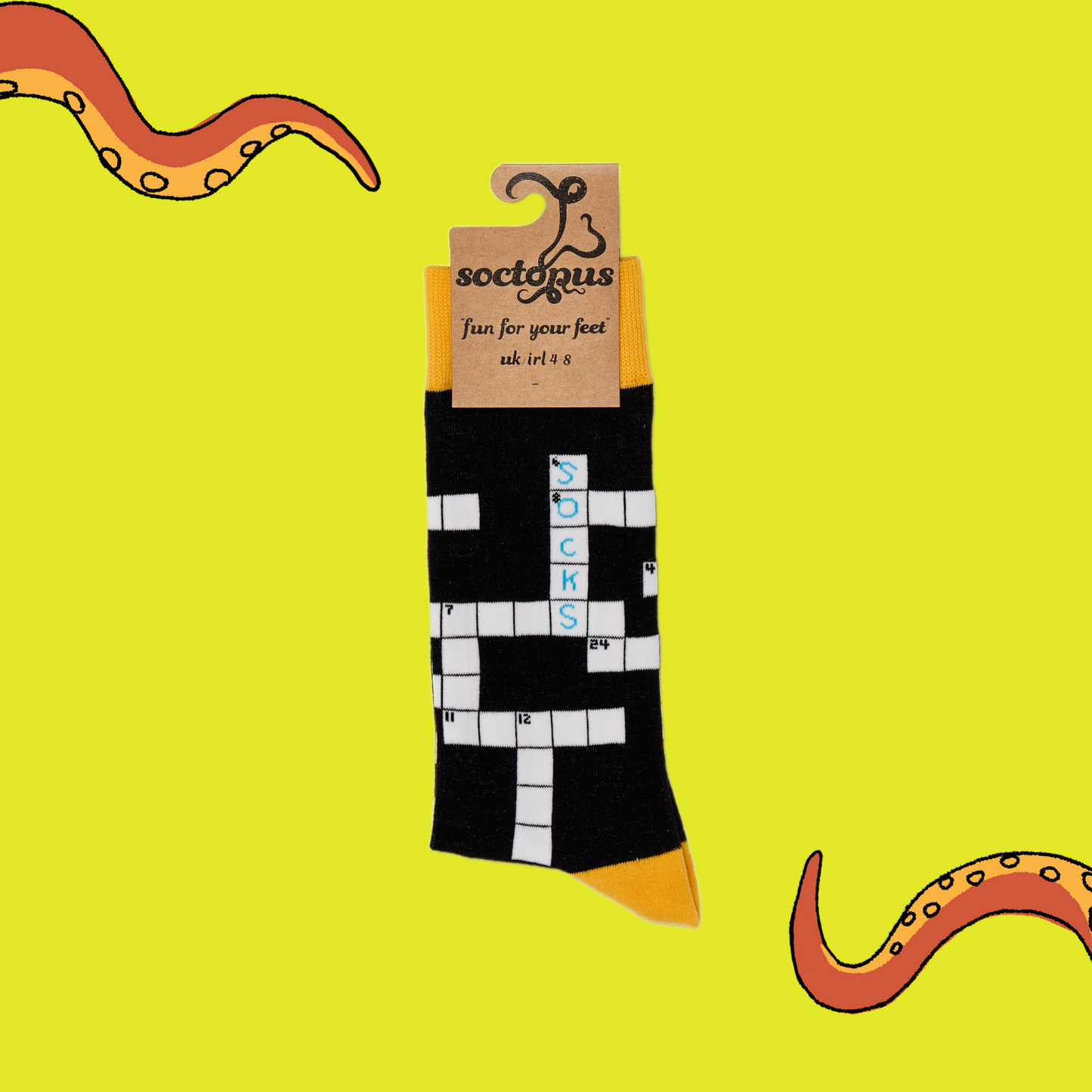 
                  
                    A pair of socks depicting Crosswords. Black legs, yellow cuff, heel and toe. In Soctopus Packaging.
                  
                