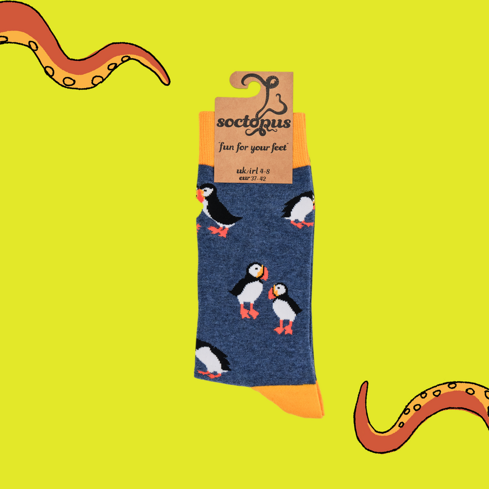 
                  
                    A pair of socks depicting tea cups and tea pots. Blue legs, yellow cuff, heel and toe. In Soctopus Packaging.
                  
                