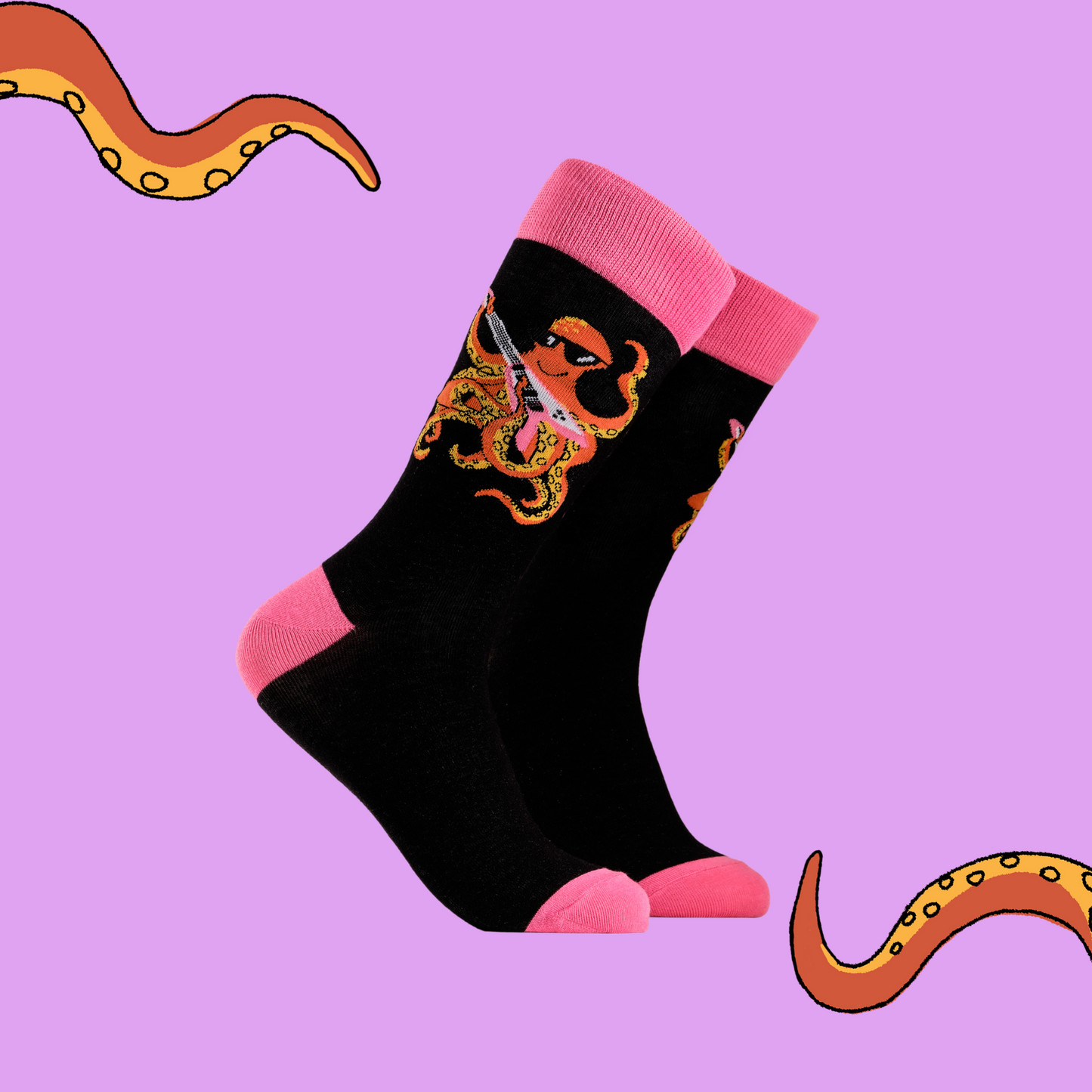 A pair of socks depicting an octopus playing a pink guitar. black legs, pink cuff, heel and toe.