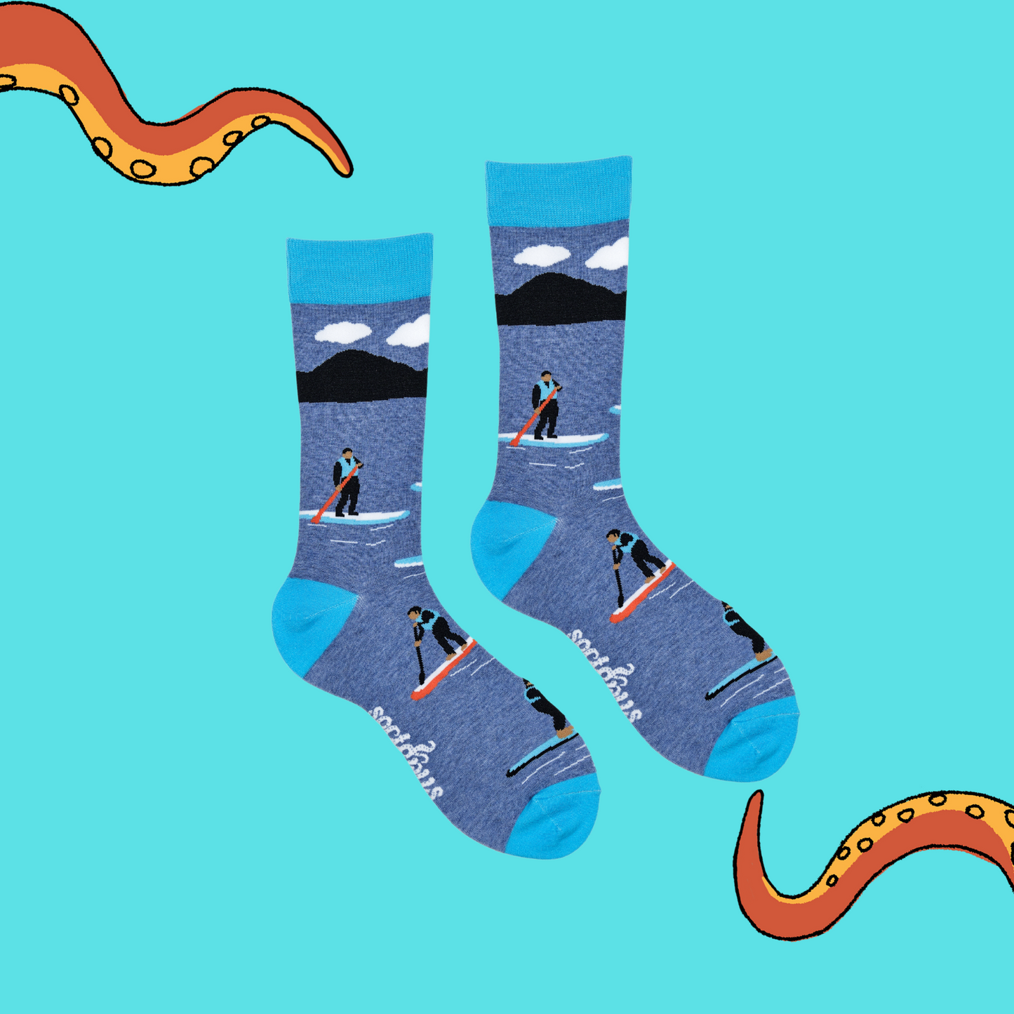 
                  
                    A pair of socks depicting paddle boarding. Blue legs, bright blue cuff, heel and toe.
                  
                