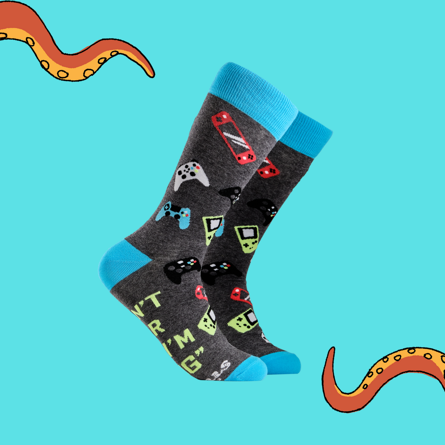 A pair of socks depicting game controllers and consoles. Grey legs, blue cuff, heel and toe.