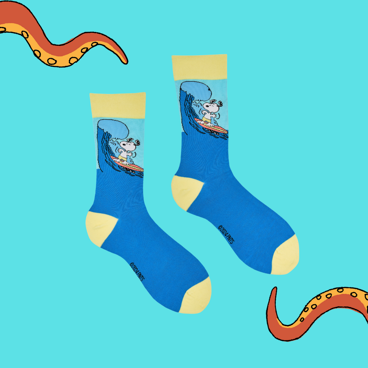 
                  
                    A pair of socks depicting snoopy catching some waves. Blue legs, yellow cuff, heel and toe.
                  
                