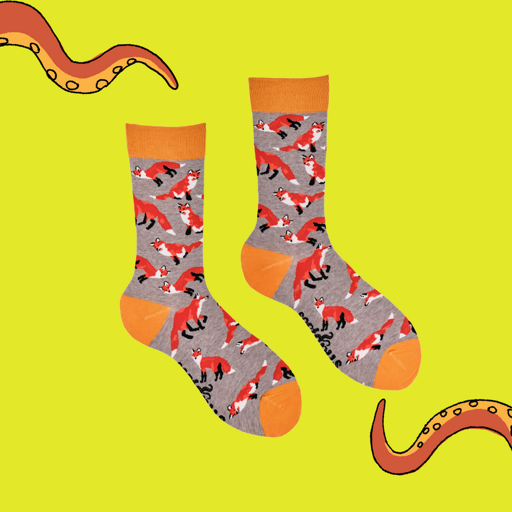 
                  
                    A pair of socks depicting playful foxes. Grey legs, orange cuff, heel and toe.
                  
                