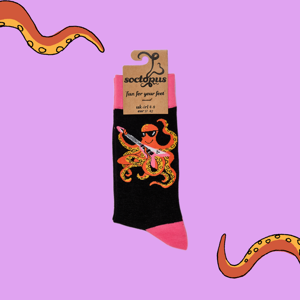 
                  
                    A pair of socks depicting an octopus playing a pink guitar. black legs, pink cuff, heel and toe. In Soctopus Packaging.
                  
                
