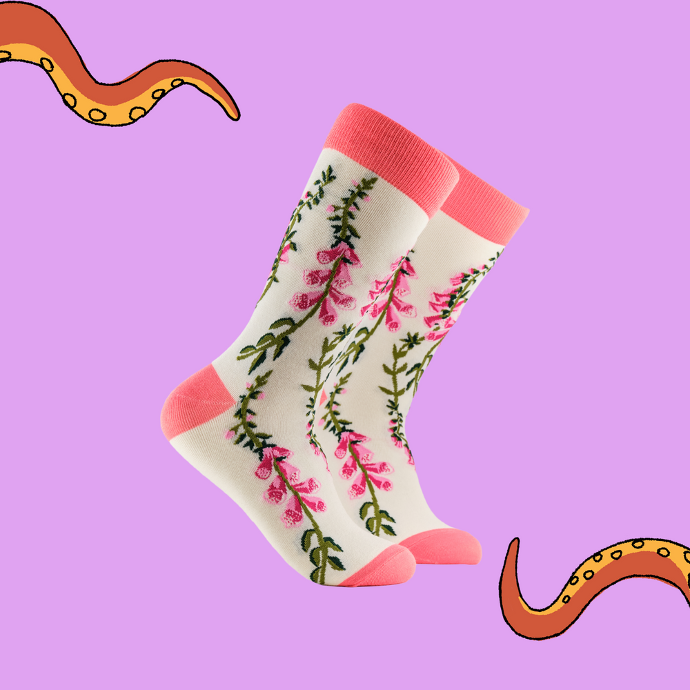 A pair of socks depicting fox gloves. Cream legs, pink cuff, heel and toe.