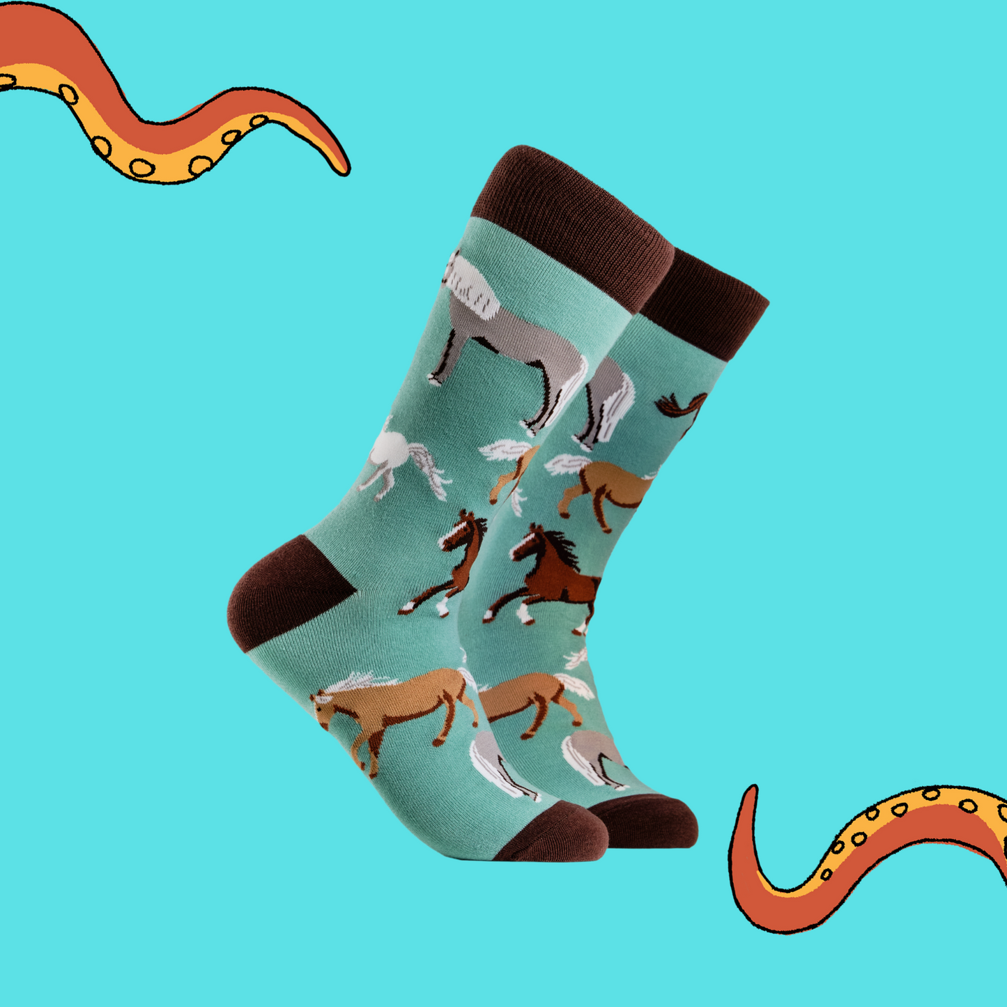 A pair of socks depicting horses. Turquoise legs, brown cuff, heel and toe.
