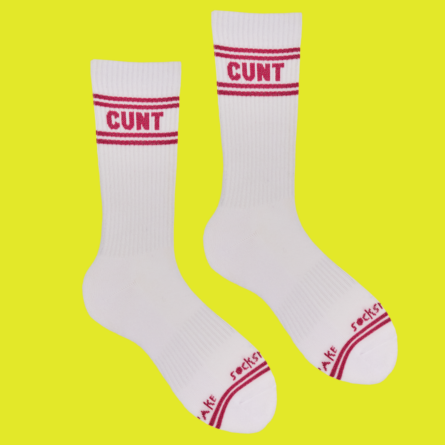 A white pair of athletic socks with red trim on the ankles and toes. A euphemism for the female genitals on the ankle.