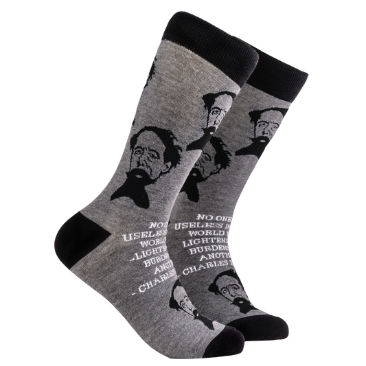 Charles Dickens Socks. A pair of socks depicting Charles Dickens and a quote. Grey legs, black cuff, heel and toe.