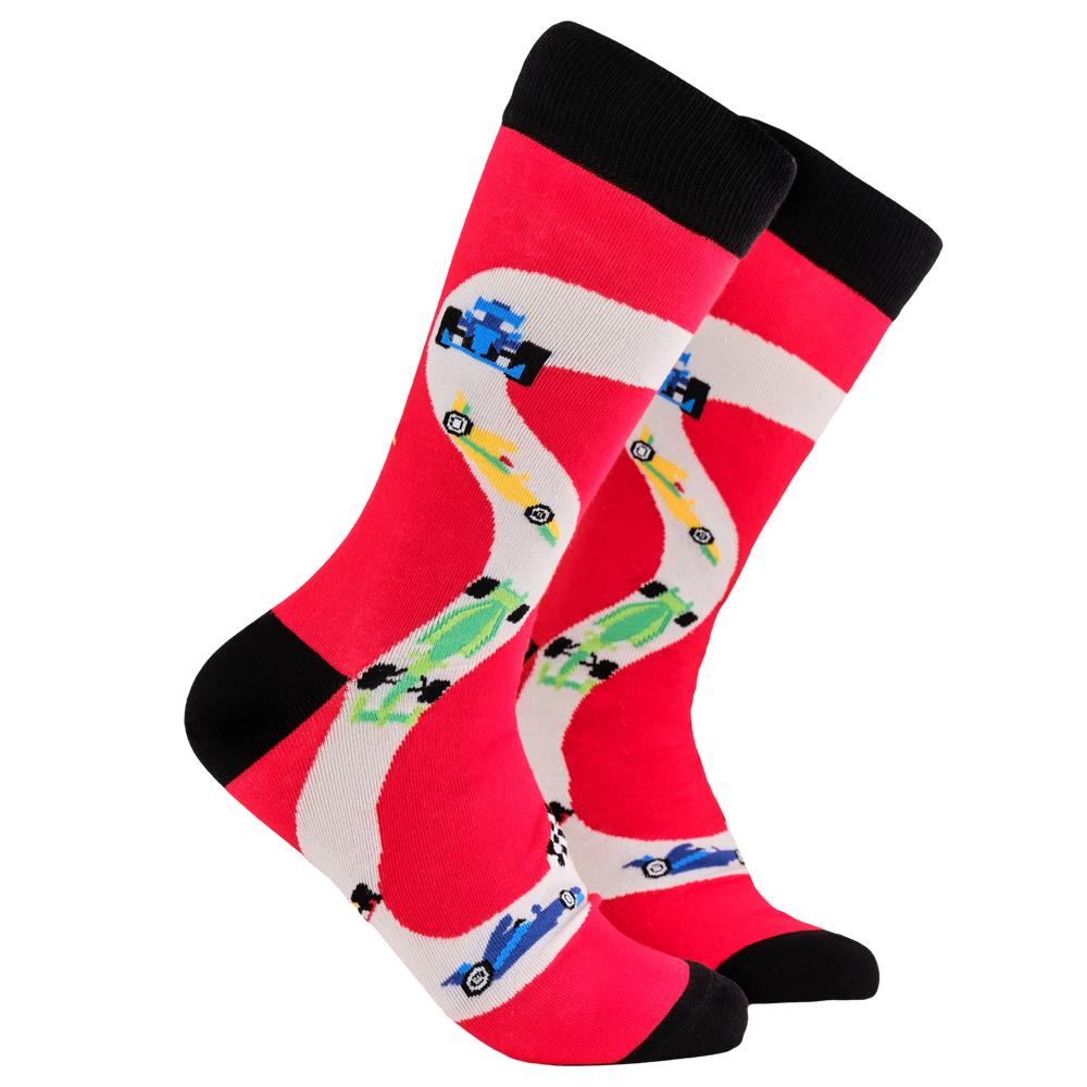 Formula 1 Socks - Chicanery. A pair of socks depicting F1 cars. Red legs, black cuff, heel and toe.