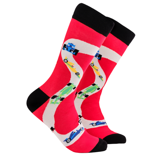 Formula 1 Socks - Chicanery. A pair of socks depicting F1 cars. Red legs, black cuff, heel and toe.