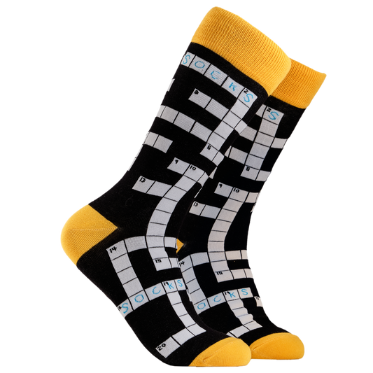 Crossword Socks. A pair of socks depicting Crosswords. Black legs, yellow cuff, heel and toe.