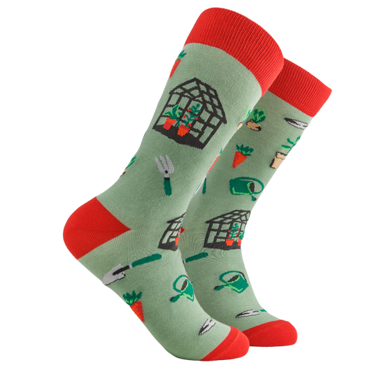 Gardening Socks - Dig These. A pair of socks depicting garden tools and greenhouses. Green legs, red cuff, heel and toe.