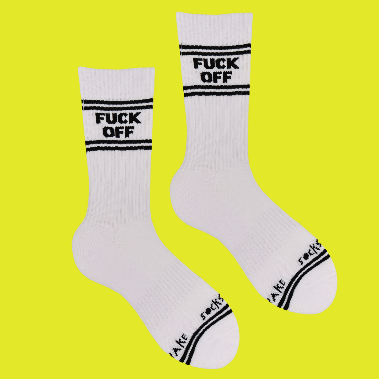 A white pair of athletic socks with black trim on the ankles and toes. And some very rude words that mean get lost on the ankle.