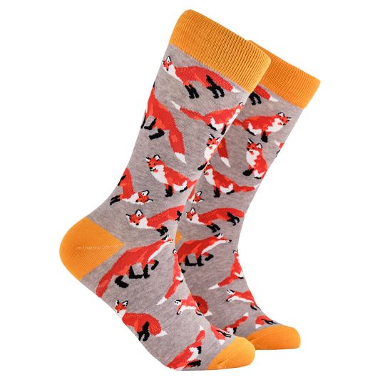 Foxes Socks. A pair of socks depicting playful foxes. Grey legs, orange cuff, heel and toe.