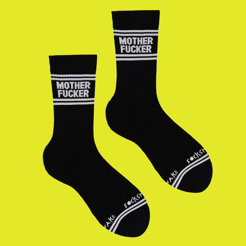 A black pair of athletic socks with white trim on the ankles and toes. With a very rude insult involving mothers on the ankle.