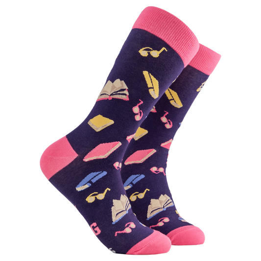 Reading Socks - Shelf Control. A pair of socks depicting books and reading glasses. Purple legs, pink cuff, heel and toe.