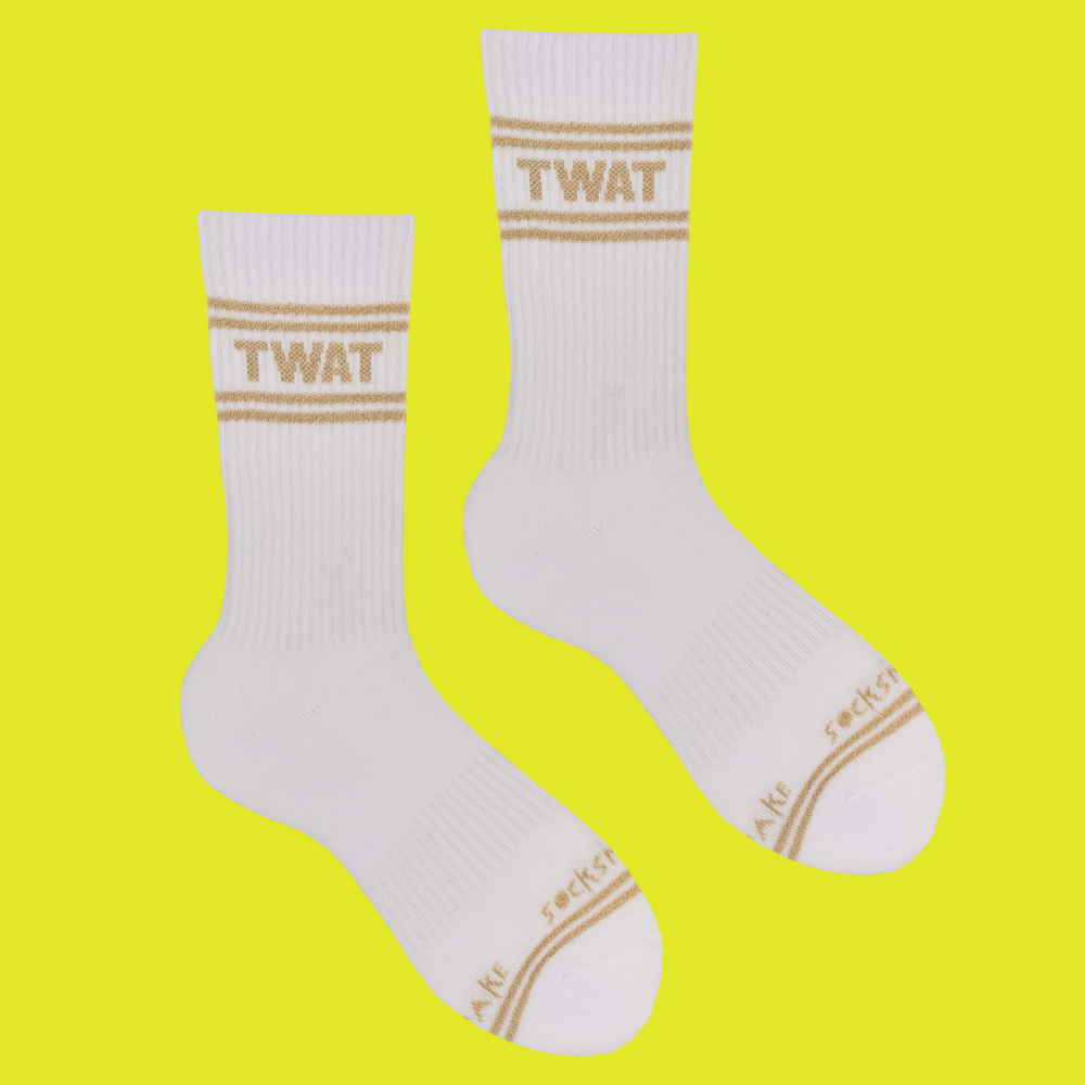 A white pair of athletic socks with gold trim on the ankles and toes. A euphemism for the female genitals on the ankle.