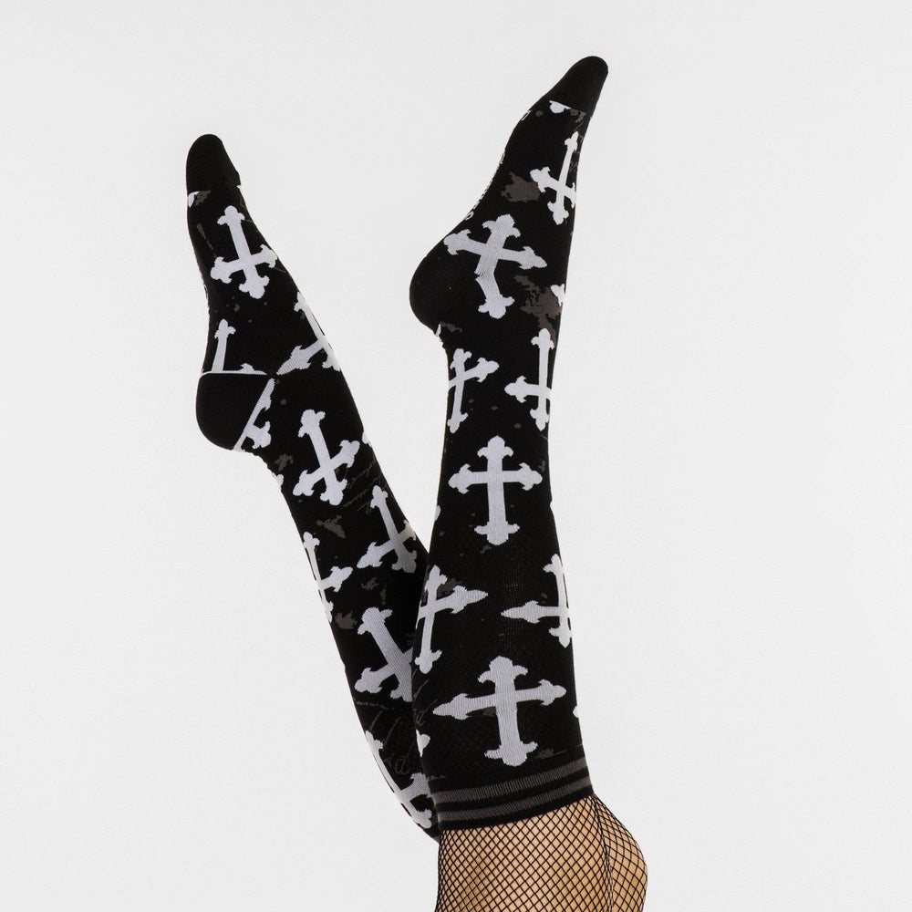 
                      
                        A pair of knee high socks with a gothic cross pattern. Black and white. 
                      
                    