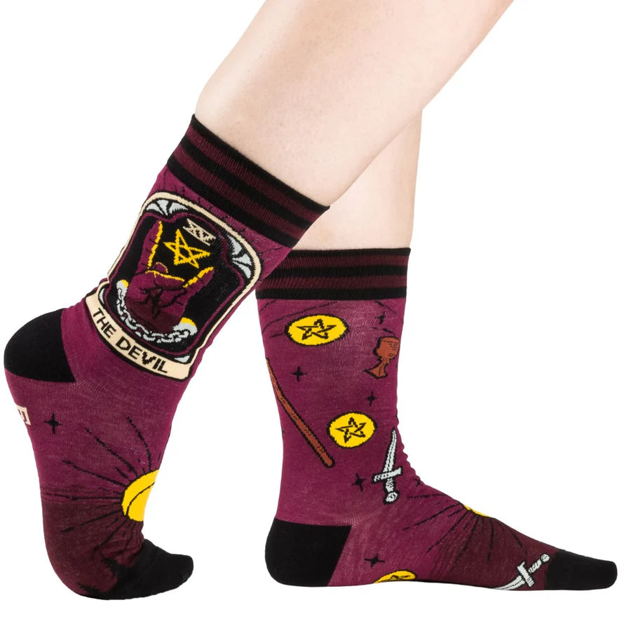 
                      
                        A model wearing a pair of socks featuring the Devil tarot card. Deep red legs, black heel, toe and cuff. 
                      
                    