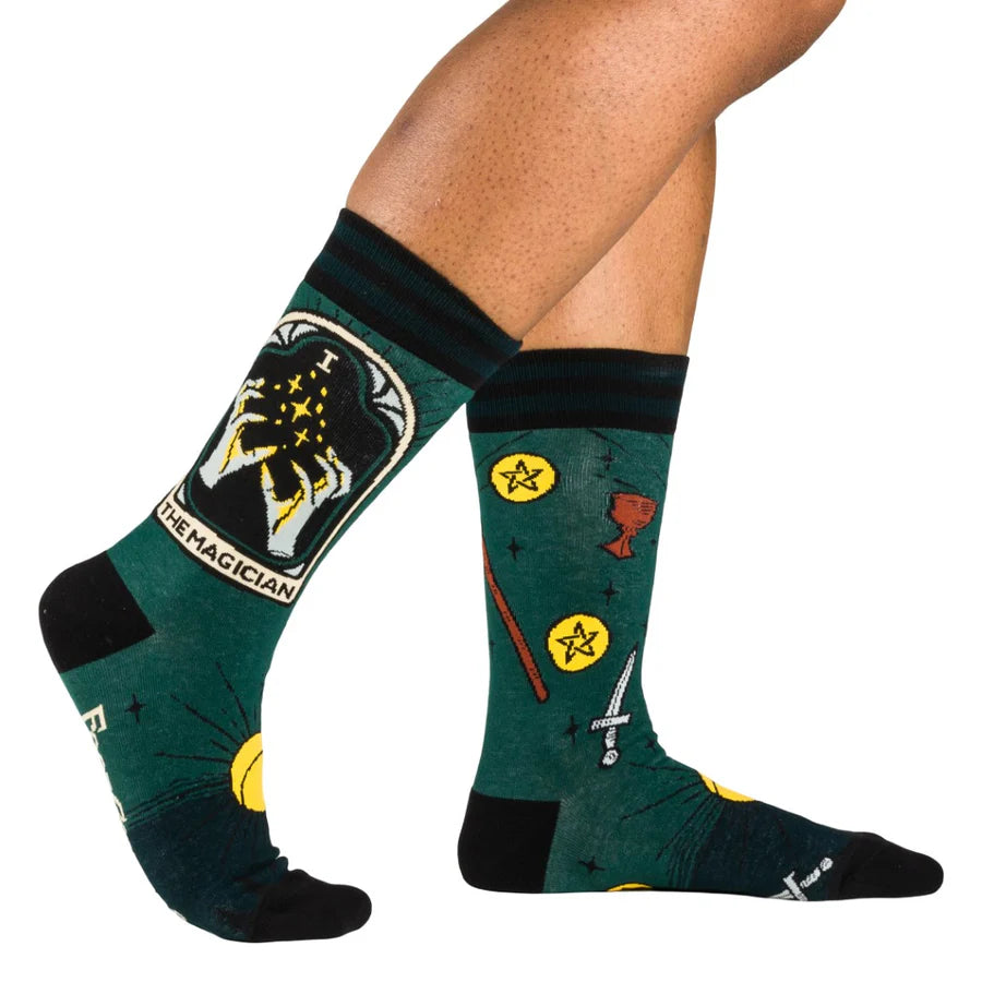 
                      
                        A model wearing a pair of socks featuring the Magician tarot card. Green legs, black heel, toe and cuff. 
                      
                    