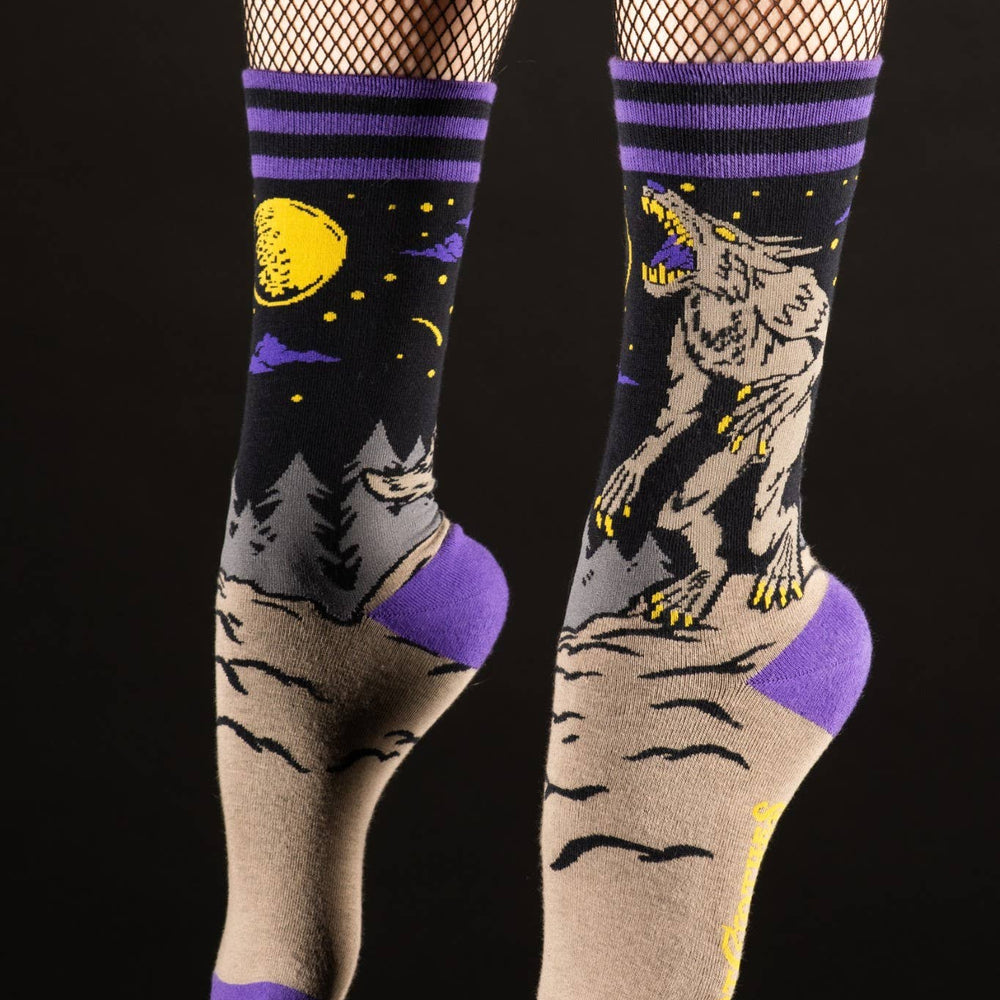 
                      
                        A model wearing a pair of socks featuring an evil werewolf design. Grey legs, purple heel, toe and cuff. 
                      
                    