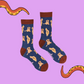 A pair of socks depicting golden retrievers. Blue legs, brown cuff, heel and toe.