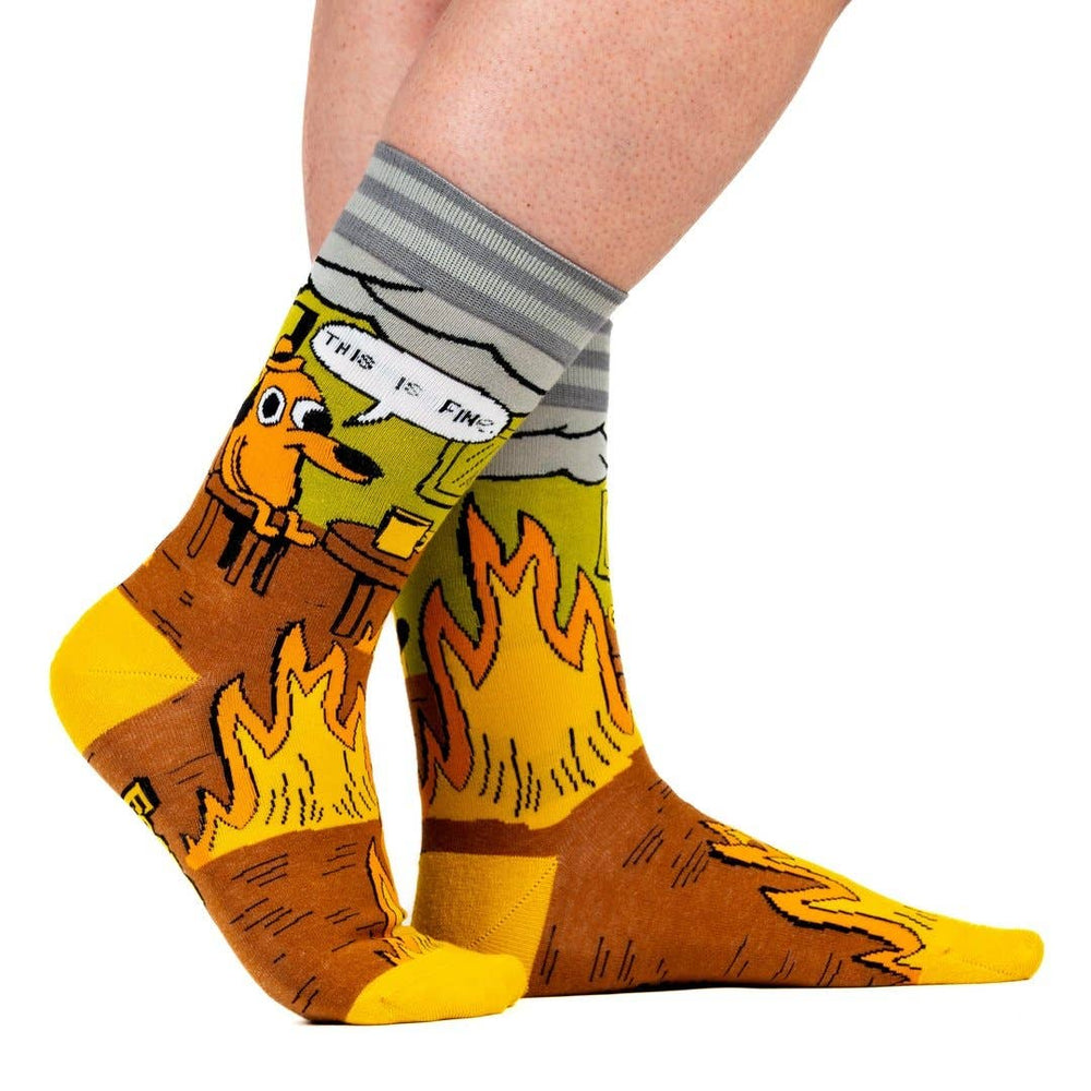 
                      
                        A model wearing a pair of socks featuring a design by KC Green. Brown flaming legs, yellow heel, toe and cuff. 
                      
                    