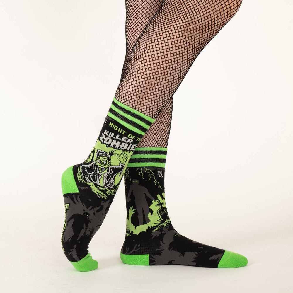 
                      
                        A model wearing a pair of socks depicting classic zombie imagery. Green toe, heel and cuff. 
                      
                    