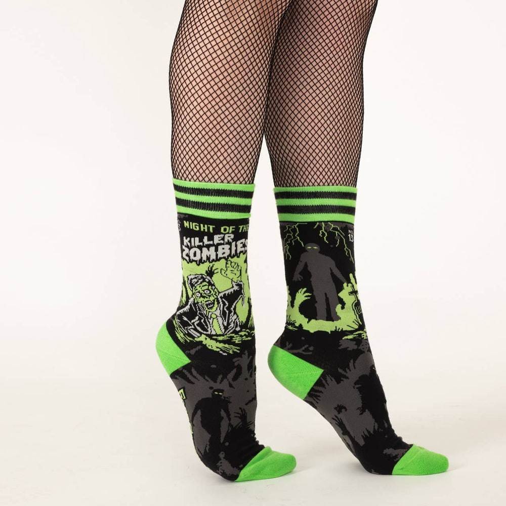 
                      
                        A model wearing a pair of socks depicting classic zombie imagery. Green toe, heel and cuff. 
                      
                    