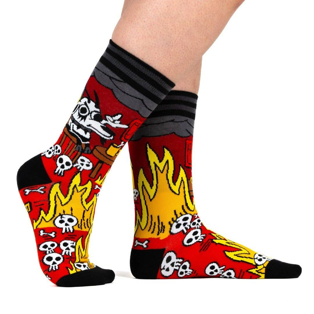 
                      
                        A model wearing a pair of socks featuring a design by KC Green. Red flaming legs, black legs, heel, toe and cuff. 
                      
                    