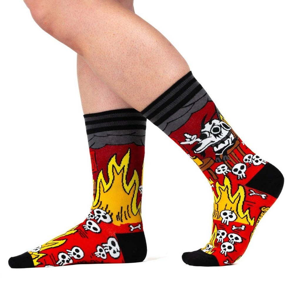 
                      
                        A model wearing a pair of socks featuring a design by KC Green. Red flaming legs, black legs, heel, toe and cuff. 
                      
                    