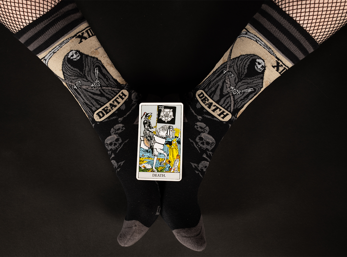 
                  
                    A pair of socks depicting the death tarot card. Grey toe, heel and cuff. 
                  
                