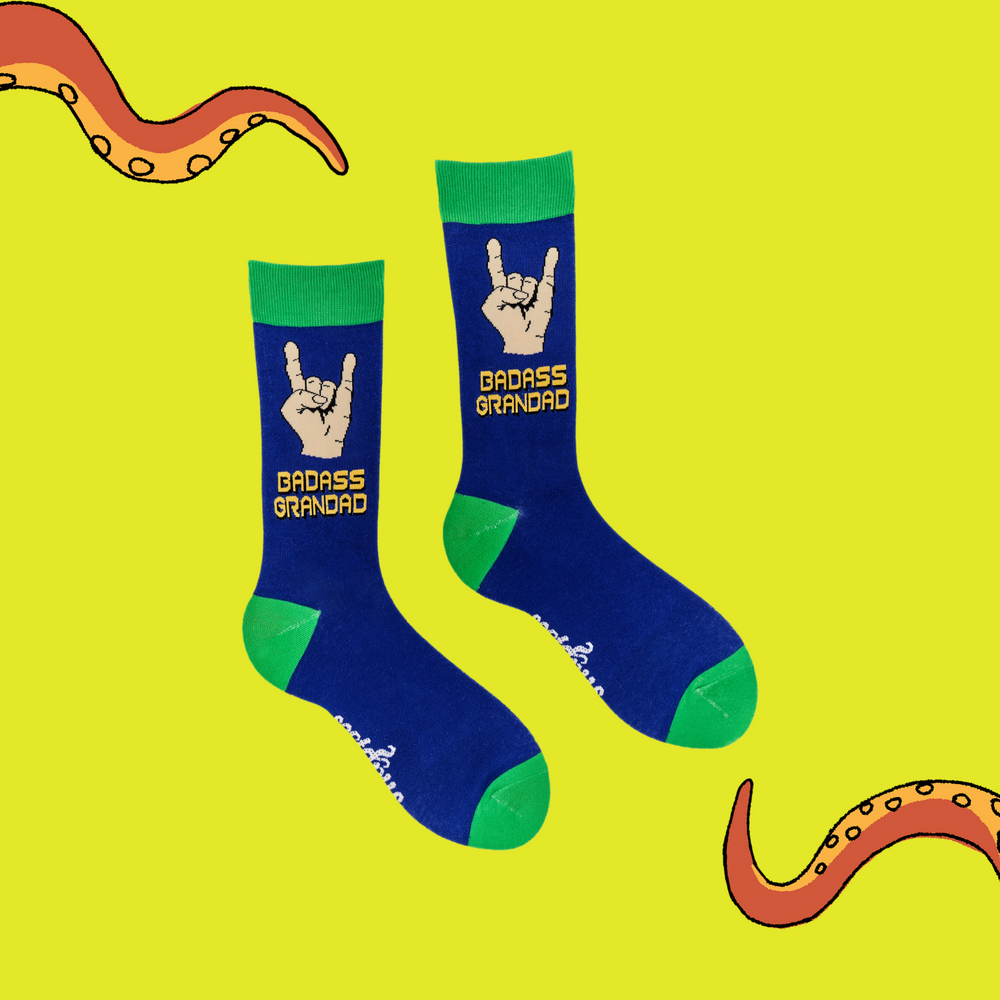 
                      
                        A pair of socks depicting metal horns that say 'Badass Grandad. Blue legs, green cuff, heel and toe.
                      
                    