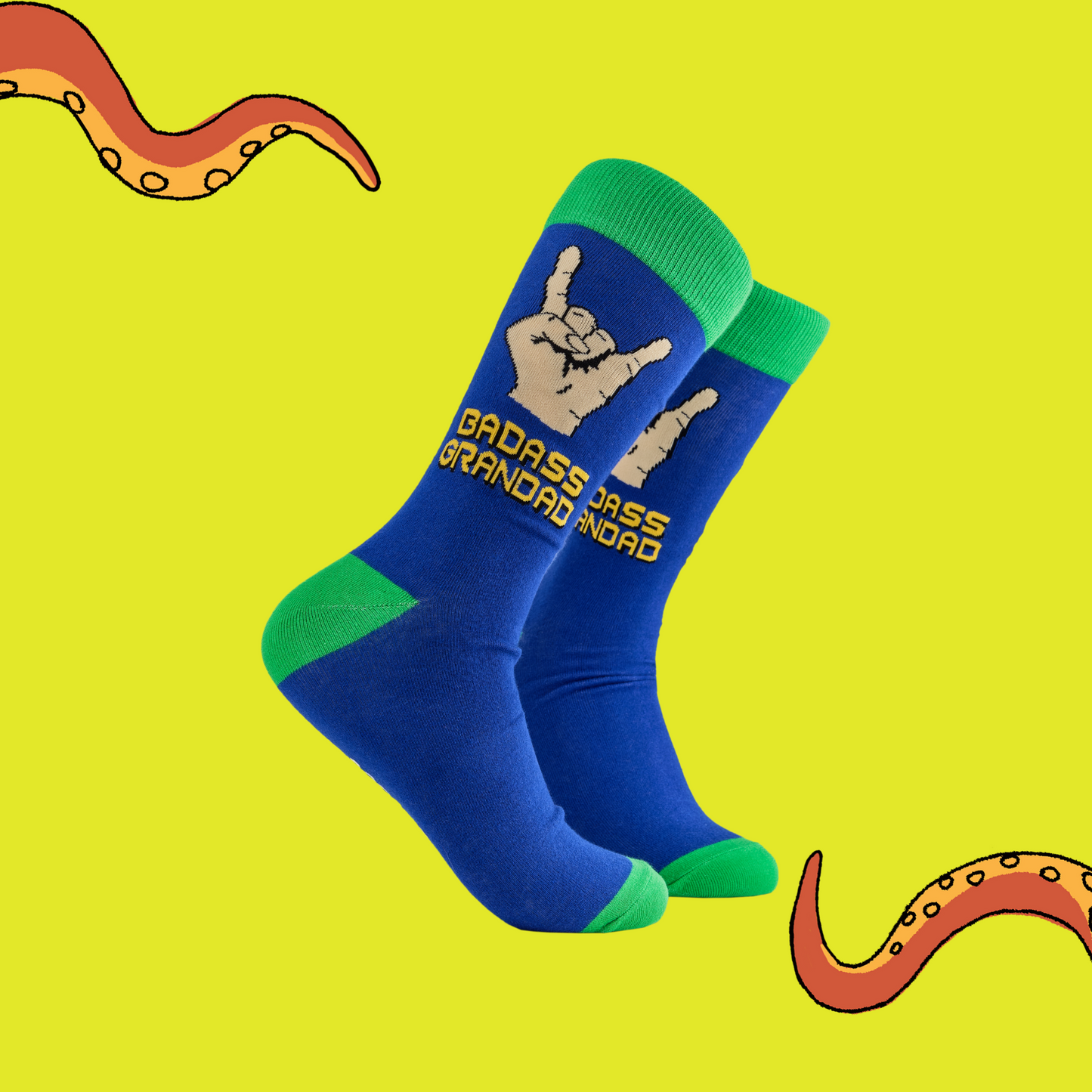 
                  
                    Badass Grandad Socks. A pair of socks depicting metal horns that say 'Badass Grandad. Blue legs, green cuff, heel and toe.
                  
                