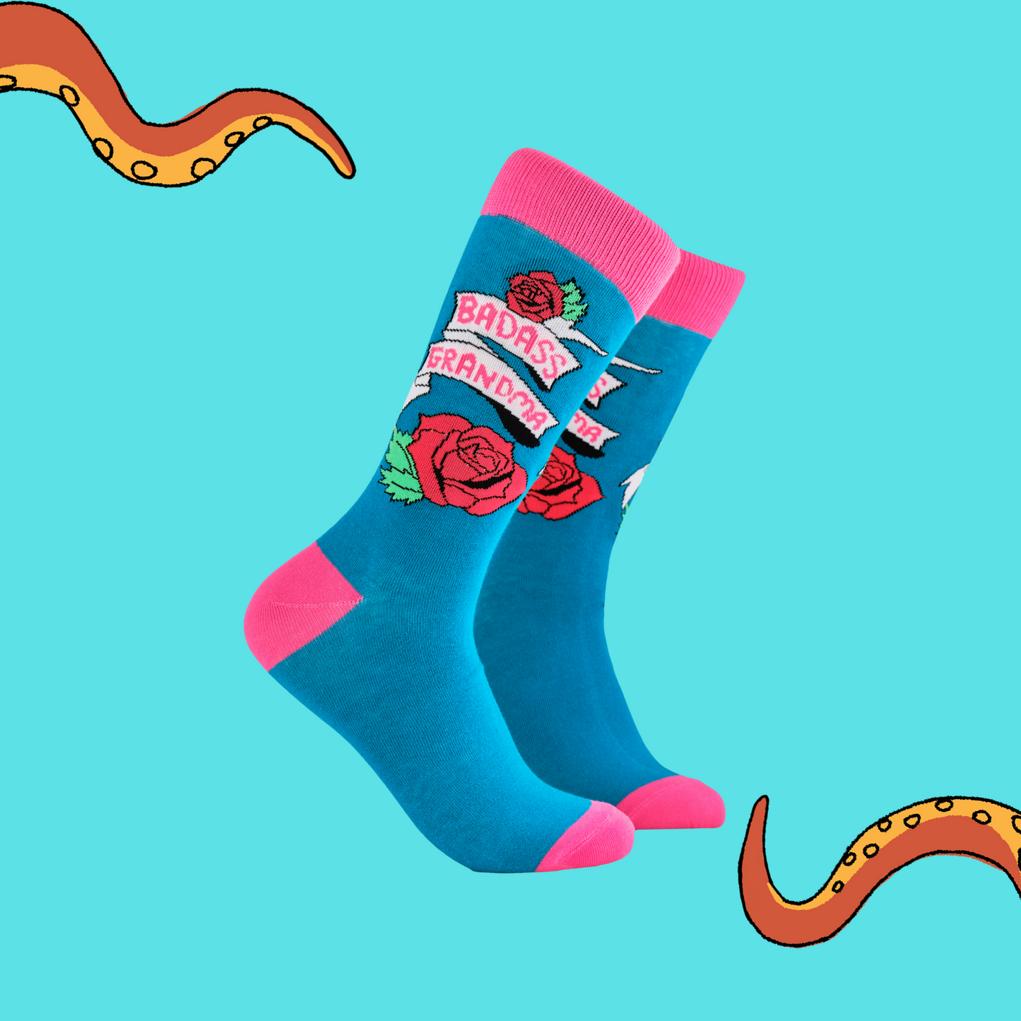 A pair of socks depicting roses and the phrase Baddass Grandma. Blue legs, pink cuff, heel and toe.
