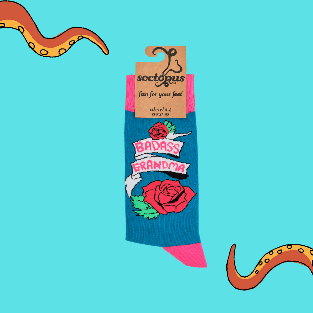 
                      
                        A pair of socks depicting roses and the phrase Baddass Grandma. Blue legs, pink cuff, heel and toe. In Soctopus Packaging.
                      
                    