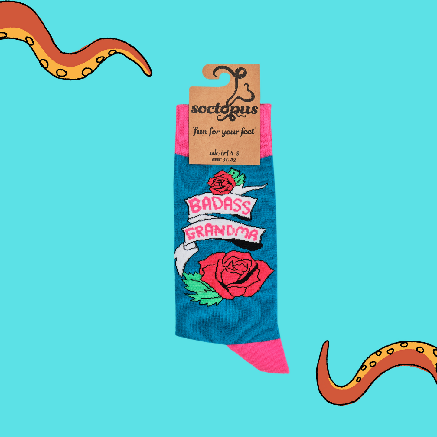
                  
                    A pair of socks depicting roses and the phrase Baddass Grandma. Blue legs, pink cuff, heel and toe. In Soctopus Packaging.
                  
                