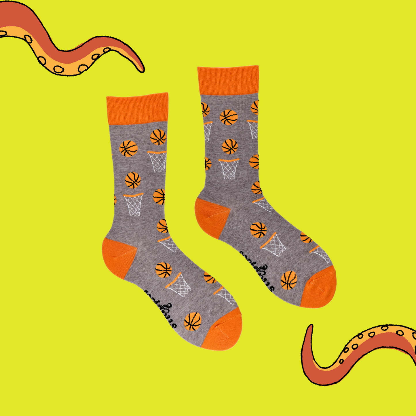 
                  
                    A pair of socks depicting basketballs. Grey legs, orange cuff, heel and toe.
                  
                